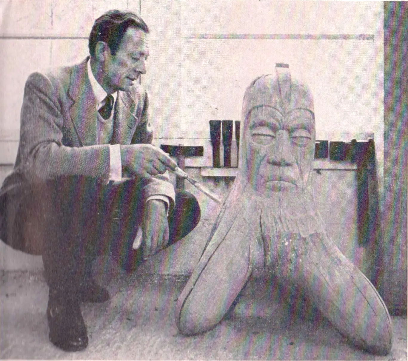 Harvey Fite seated beside his sculpture Mars