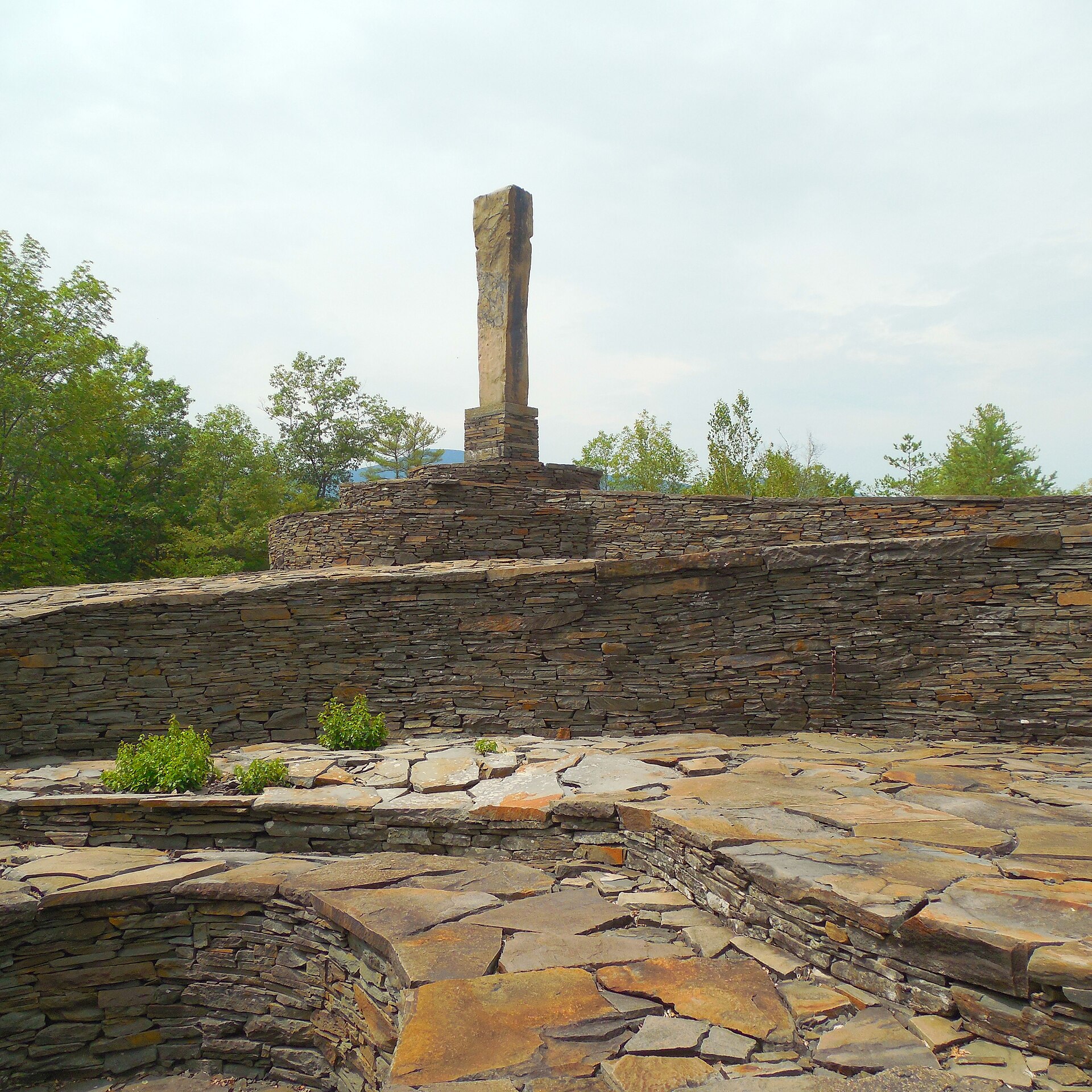 Opus 40 monolith viewed across layered bluestone