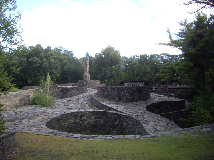 Opus 40 stonework below trees and open sky