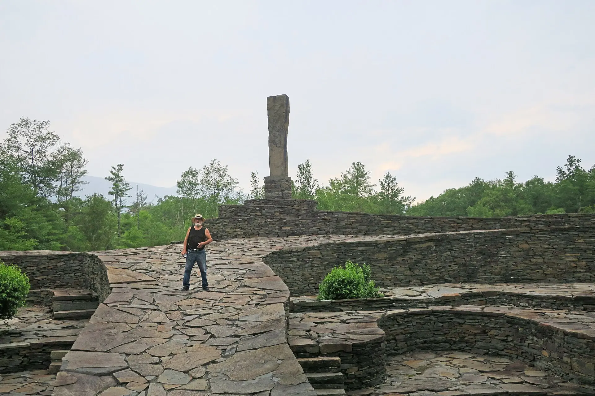 Visitors walking a curved bluestone ramp at Opus 40